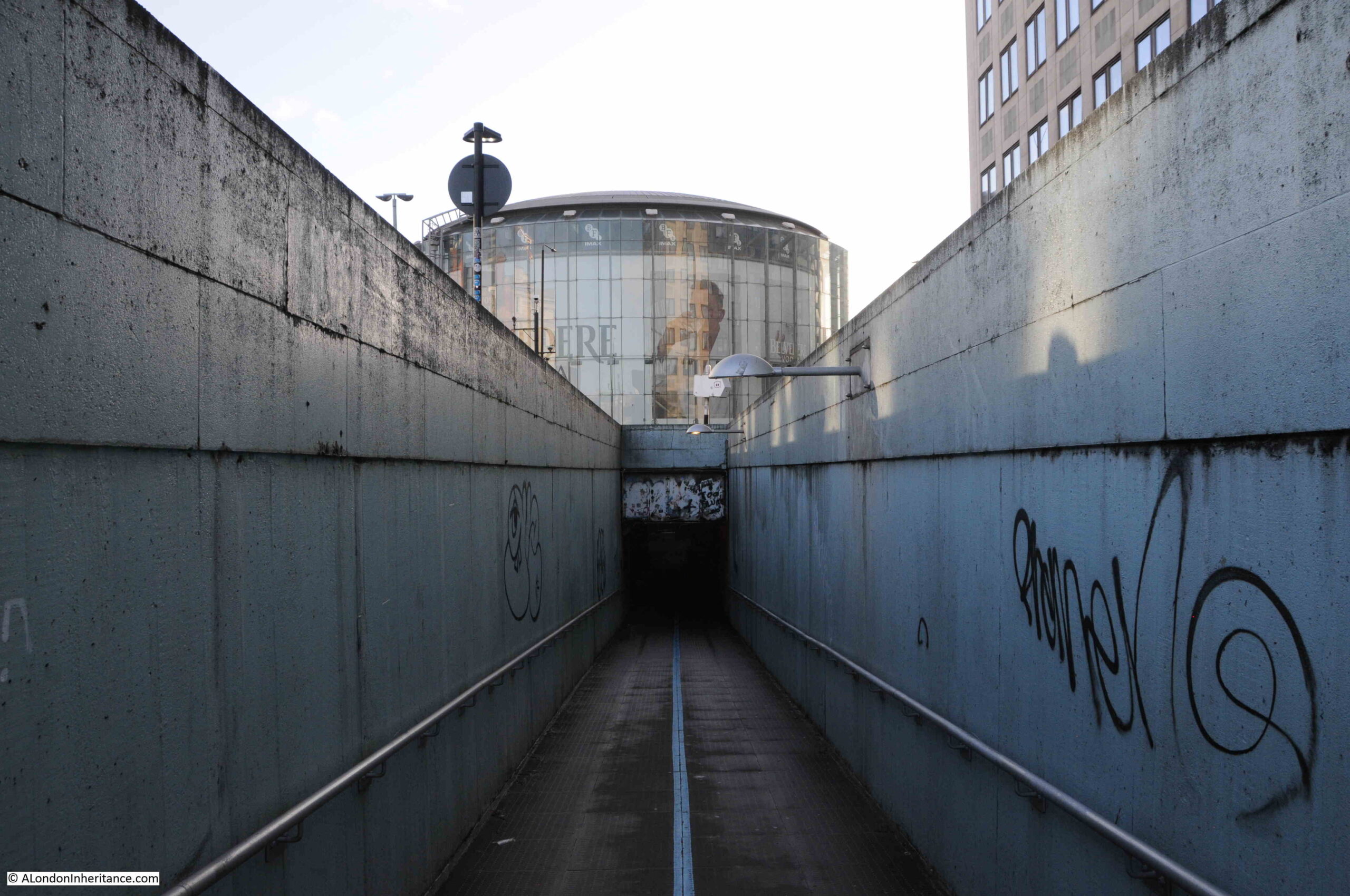 Underground tunnel leading up to Waterloo bridge with IMAX in background
